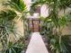 Charming walkway with lush greenery, leading to a private gate at 2410 W Azeele St # 220, Tampa, FL 33609