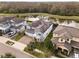 Aerial view of a stunning home with solar panels next to a serene lake at 2641 Whittler Br, Odessa, FL 33556