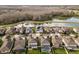 Aerial view of a neighborhood with a home with solar panels, screened pool, and lake at 2641 Whittler Br, Odessa, FL 33556