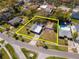 Aerial view showcasing the property's layout and surrounding neighborhood with mature trees and nearby amenities at 27 Park Ave, Tarpon Springs, FL 34689