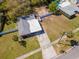 Aerial view of a well-maintained single-story home featuring a spacious yard and a long driveway at 27 Park Ave, Tarpon Springs, FL 34689