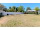 Expansive backyard with lush green grass and a well-maintained white fence, offering privacy and space at 27 Park Ave, Tarpon Springs, FL 34689