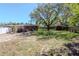 Large backyard with mature trees, a garden shed, and plenty of open space for outdoor activities at 27 Park Ave, Tarpon Springs, FL 34689