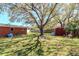 Large backyard features a shed and mature shade trees for outdoor living and entertaining at 27 Park Ave, Tarpon Springs, FL 34689