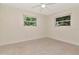 Cozy bedroom featuring neutral walls, carpet floors, two windows letting in natural light at 27 Park Ave, Tarpon Springs, FL 34689