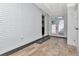 Spacious bonus room showcasing a painted brick wall and seamless outdoor access at 27 Park Ave, Tarpon Springs, FL 34689