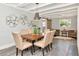 Dining area featuring a wood table, upholstered chairs, and decorative wall art with an open layout at 27 Park Ave, Tarpon Springs, FL 34689