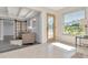 Bright foyer with a decorative glass door and an open floor plan leading into the living area at 27 Park Ave, Tarpon Springs, FL 34689