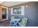 Inviting front porch features an outdoor seating area with a round table and two chairs at 27 Park Ave, Tarpon Springs, FL 34689