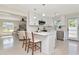 Open-concept kitchen featuring white cabinets, stainless appliances, and bar seating at 27 Park Ave, Tarpon Springs, FL 34689