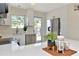 Well-lit kitchen featuring white countertops, modern appliances, and backyard access at 27 Park Ave, Tarpon Springs, FL 34689