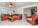 Inviting living room features leather seating, a wooden coffee table and plenty of natural light at 27 Park Ave, Tarpon Springs, FL 34689