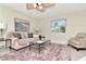 Cozy living room featuring a plush rug, comfortable seating, and a large window for natural light at 27 Park Ave, Tarpon Springs, FL 34689