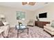 Inviting living room with stylish furniture, entertainment center, and soft, neutral colors at 27 Park Ave, Tarpon Springs, FL 34689