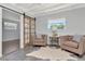 Cozy sitting area with tufted armchairs, barn door and natural light, perfect for relaxation and reading at 27 Park Ave, Tarpon Springs, FL 34689