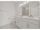 Elegant bathroom featuring double sinks, white cabinets, and a glass-enclosed shower at 305 15Th N St, St Petersburg, FL 33705