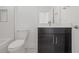 Clean bathroom with dark vanity, modern toilet, and bathtub at 305 15Th N St, St Petersburg, FL 33705