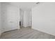 Bright bedroom featuring sleek wood-look floors, a double door closet and neutral walls at 305 15Th N St, St Petersburg, FL 33705