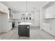 Modern eat-in kitchen featuring white cabinets, stylish island, stainless appliances and contemporary lighting at 305 15Th N St, St Petersburg, FL 33705