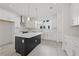 Bright, modern kitchen with white cabinetry, a contrasting island, stainless steel appliances, and marble backsplash at 305 15Th N St, St Petersburg, FL 33705