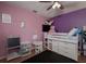 Bedroom with pink and purple walls, loft bed with storage, and ceiling fan at 3159 138Th Pl, Largo, FL 33771