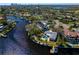 Waterfront property featuring a private pool, boat dock, and lush tropical landscaping with views of the city skyline at 3399 Maple Ne St, St Petersburg, FL 33704
