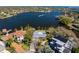 Stunning waterfront property with a pool, boat dock, and lush landscaping surrounded by sparkling waters and neighborhood views at 3399 Maple Ne St, St Petersburg, FL 33704
