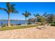 Brick patio featuring lawn chairs and views of the waterfront and tropical landscaping at 3399 Maple Ne St, St Petersburg, FL 33704