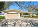 Charming single-Gathering home with a two-car garage, a well-manicured lawn, and a welcoming green front door at 3399 Maple Ne St, St Petersburg, FL 33704