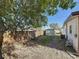 Large fenced backyard with a storage shed, some grass, and mature trees at 3501 Beechwood N Ter, Pinellas Park, FL 33781