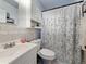 Cozy bathroom with a shower-tub combo featuring a vanity with mirror and botanical curtain at 3501 Beechwood N Ter, Pinellas Park, FL 33781