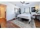Comfortable bedroom featuring a ceiling fan, wood floors, and unique decor, creating a cozy retreat at 3501 Beechwood N Ter, Pinellas Park, FL 33781