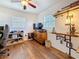 Well-lit bedroom with a ceiling fan, wood flooring, and built-in shelves for a functional space at 3501 Beechwood N Ter, Pinellas Park, FL 33781