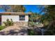Well-maintained home featuring stone accents, landscaping, and a screened-in porch at 3501 Beechwood N Ter, Pinellas Park, FL 33781