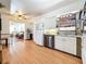 Bright kitchen with white cabinets, stainless steel appliances, and a view into the connected living space at 3501 Beechwood N Ter, Pinellas Park, FL 33781