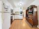 Charming kitchen featuring white cabinets, light wood flooring, and modern appliances for a bright, clean space at 3501 Beechwood N Ter, Pinellas Park, FL 33781