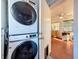 Bright laundry area featuring stacked washer and dryer, leading to the rest of home at 3501 Beechwood N Ter, Pinellas Park, FL 33781