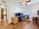 Spacious office space with wood floors, a large desk area, and views into an adjoining living room at 3501 Beechwood N Ter, Pinellas Park, FL 33781