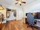 Office/bedroom with closet, computer, chair, and wood floors with a view into the living room at 3501 Beechwood N Ter, Pinellas Park, FL 33781