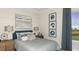 Cozy bedroom with a large window, featuring tasteful decor and comfortable furnishings at 3583 Santa Caterina Blvd, Bradenton, FL 34211