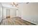 Bedroom with laminate floors, neutral walls, and a view to an adjacent room at 3767 Orchard Highlands Dr, Palm Harbor, FL 34684