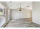 Bright living room with wood floors, vaulted ceiling, modern chandelier, and lots of natural light at 3767 Orchard Highlands Dr, Palm Harbor, FL 34684