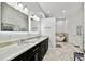 Bright bathroom boasts dual sinks, a luxurious soaking tub, and elegant marble flooring, creating a spa-like retreat at 3844 Wellington Pkwy, Palm Harbor, FL 34685