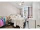 Cozy bedroom with a large window, soft lighting, and charming decor, creating a serene and inviting atmosphere at 3844 Wellington Pkwy, Palm Harbor, FL 34685