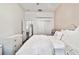 Bright bedroom featuring a large bed, white dresser, and closet with sliding doors at 3844 Wellington Pkwy, Palm Harbor, FL 34685