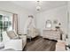 Charming Bedroom with a crib, decorative mirror, chandelier, glider, and elegant furnishings at 3844 Wellington Pkwy, Palm Harbor, FL 34685