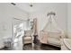 Elegant Bedroom featuring a crib with canopy, comfortable glider, and ample natural light at 3844 Wellington Pkwy, Palm Harbor, FL 34685