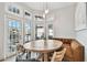 Dining area features a round table, built-in booth seating, and views of the outdoor pool at 3844 Wellington Pkwy, Palm Harbor, FL 34685
