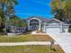 Stunning single-story home with meticulously maintained lawn and a three car garage at 3844 Wellington Pkwy, Palm Harbor, FL 34685