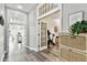 Hallway leading into office with French doors, neutral paint and hardwood style floors at 3844 Wellington Pkwy, Palm Harbor, FL 34685
